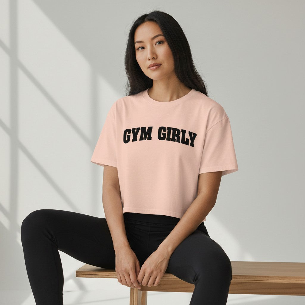 GYM PANTHERS light pink cotton crop top with black "Gym Girly" text. Relaxed fit, short sleeves, crew neck.