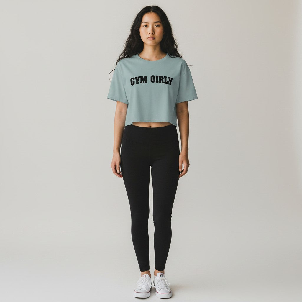 GYM PANTHERS light blue cotton blend crop top with black 'Gym Girly' text graphic. Relaxed fit, short sleeves.