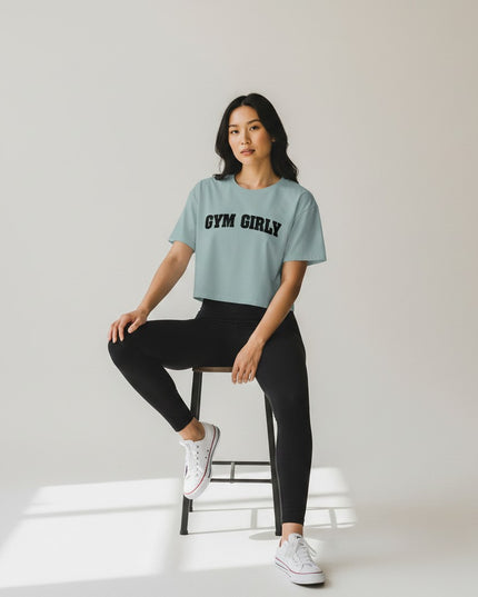 GYM PANTHERS light blue cotton blend crop top with black 'Gym Girly' text graphic. Relaxed fit, short sleeves.
