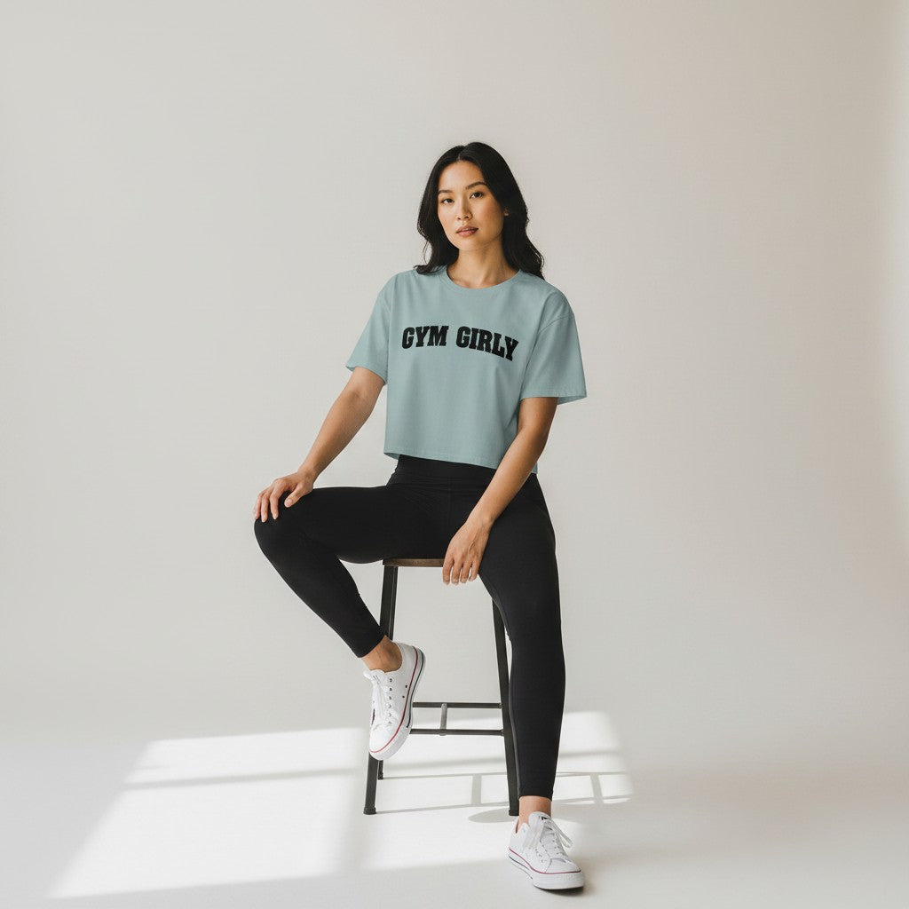 GYM PANTHERS light blue cotton blend crop top with black 'Gym Girly' text graphic. Relaxed fit, short sleeves.