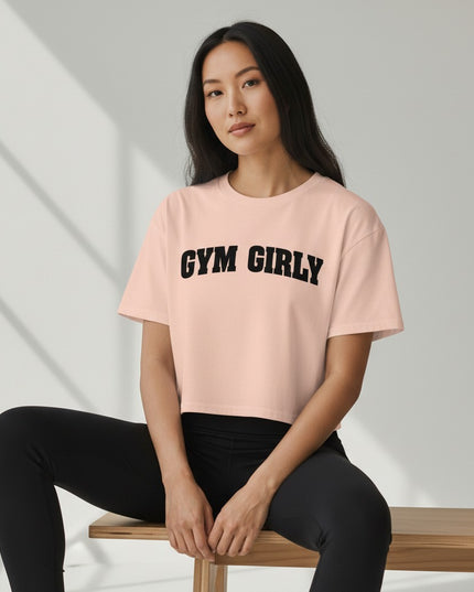 GYM PANTHERS light pink cotton crop top with black "Gym Girly" text. Relaxed fit, short sleeves, crew neck.
