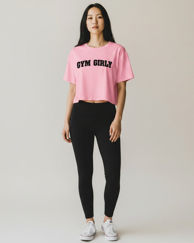 GYM PANTHERS pink cotton crop top with black 'Gym Girly' text, short sleeves, crew neck, relaxed fit.